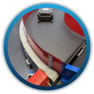 M2i modular curved belt conveyor carrying baggage around a bend